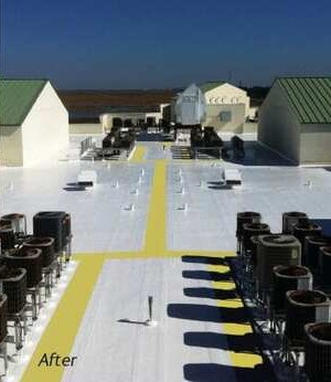 The same commercial flat roof after a seamless reflective silicone coating and marked walkways were applied